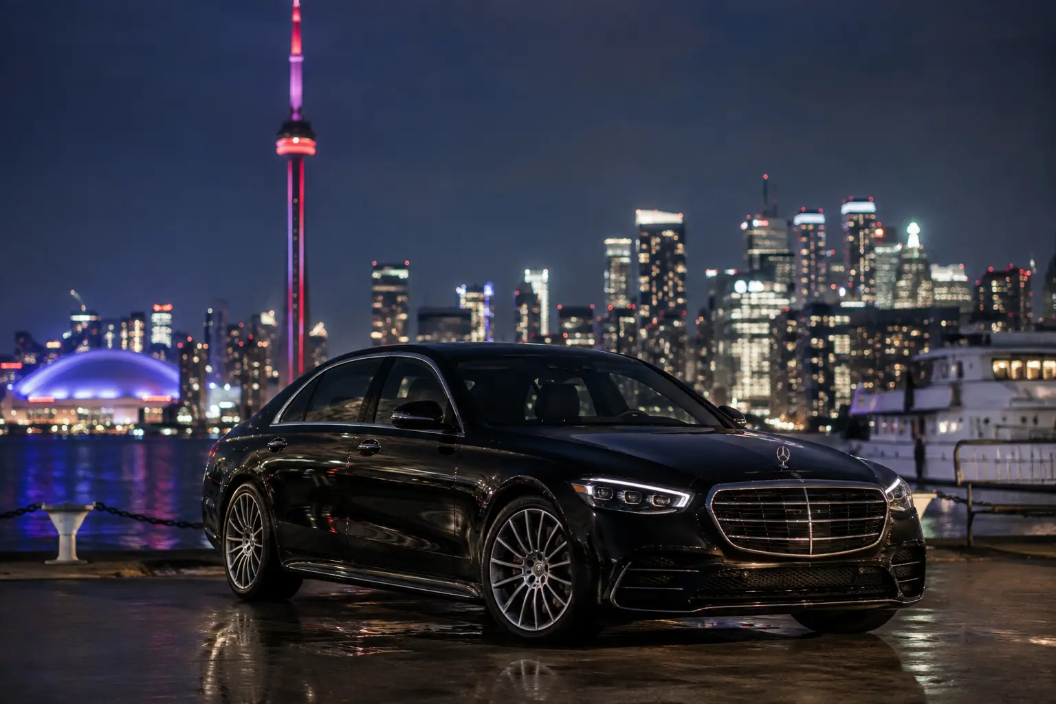 Black chauffeur vehicle on a downtown Toronto street at night