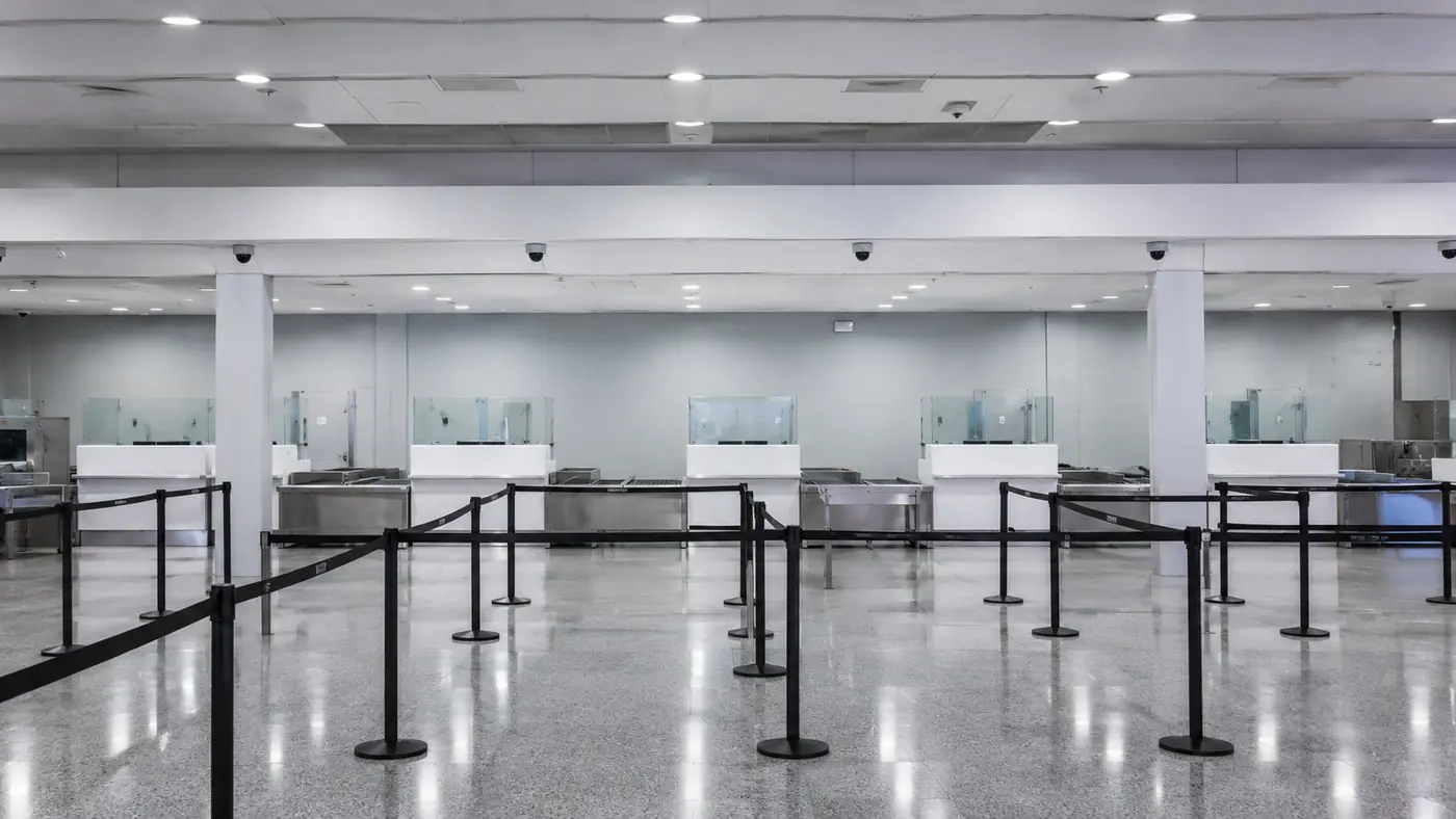 Row of inspection counters with queue lanes in an international arrivals customs hall