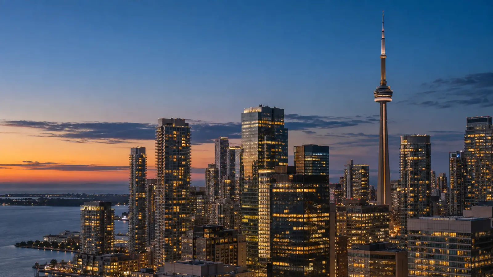 Downtown Toronto towers and lit hotel windows at dusk, showing the central area most guides recommend when deciding where to stay in Toronto